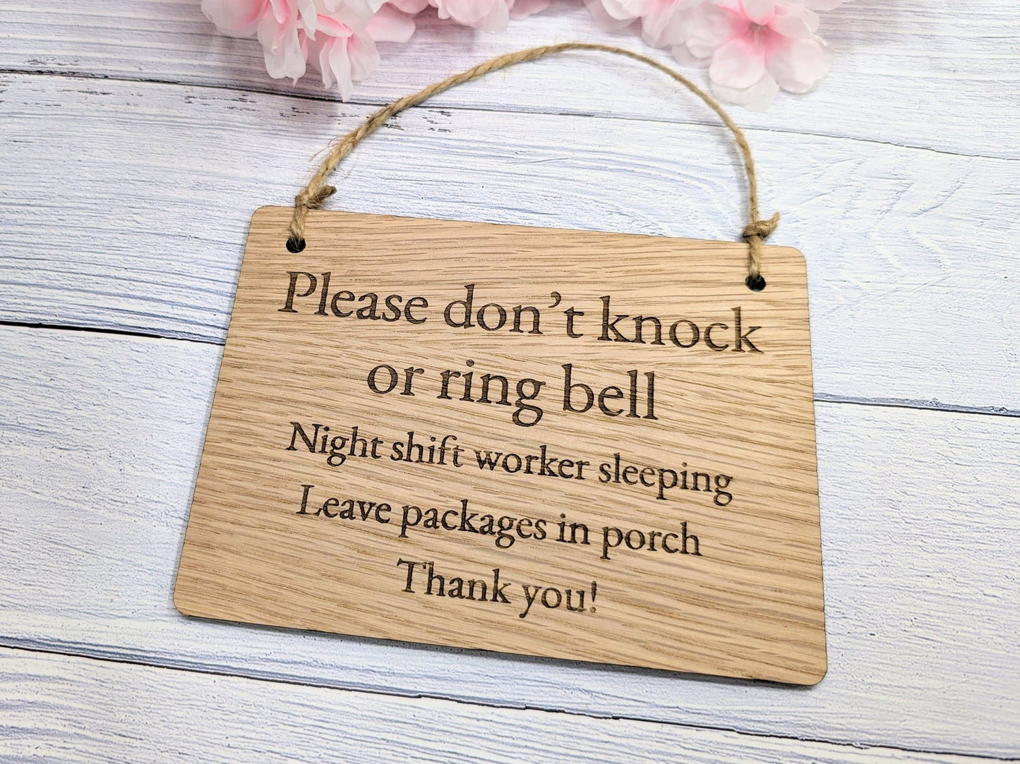 Bamboo night shift sign close-up — engraved message, natural grain