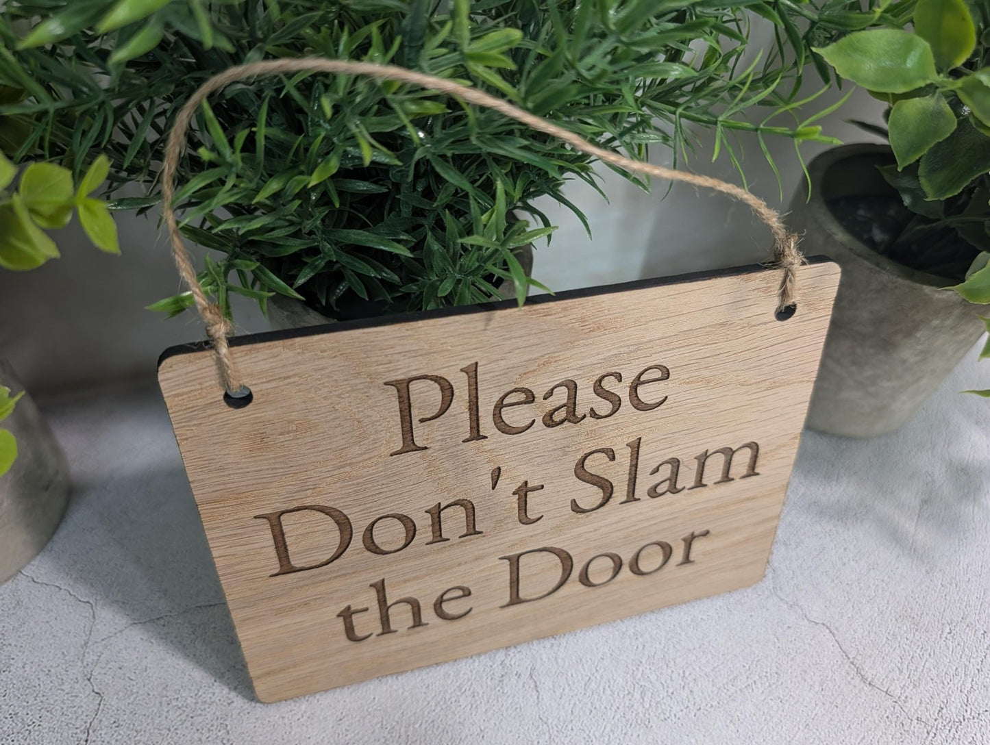 Don't Slam the Door hanging sign in home office setting, oak veneer