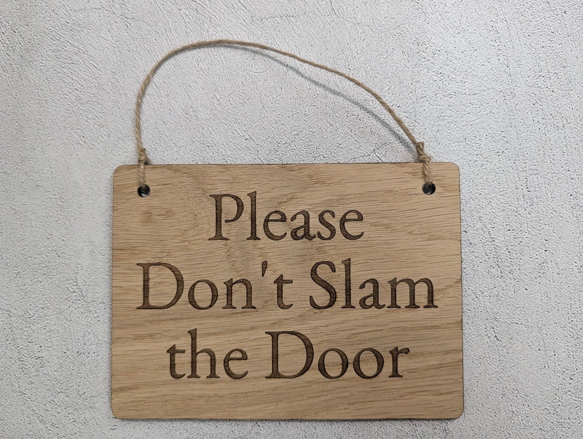 Don't Slam the Door oak sign close-up, laser-engraved text on jute loop