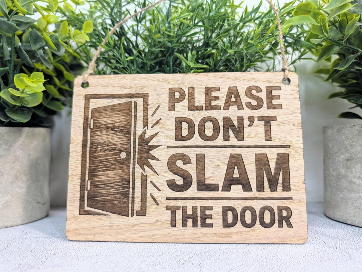 Door Icon sign close-up showing illustrated door graphic, oak veneer