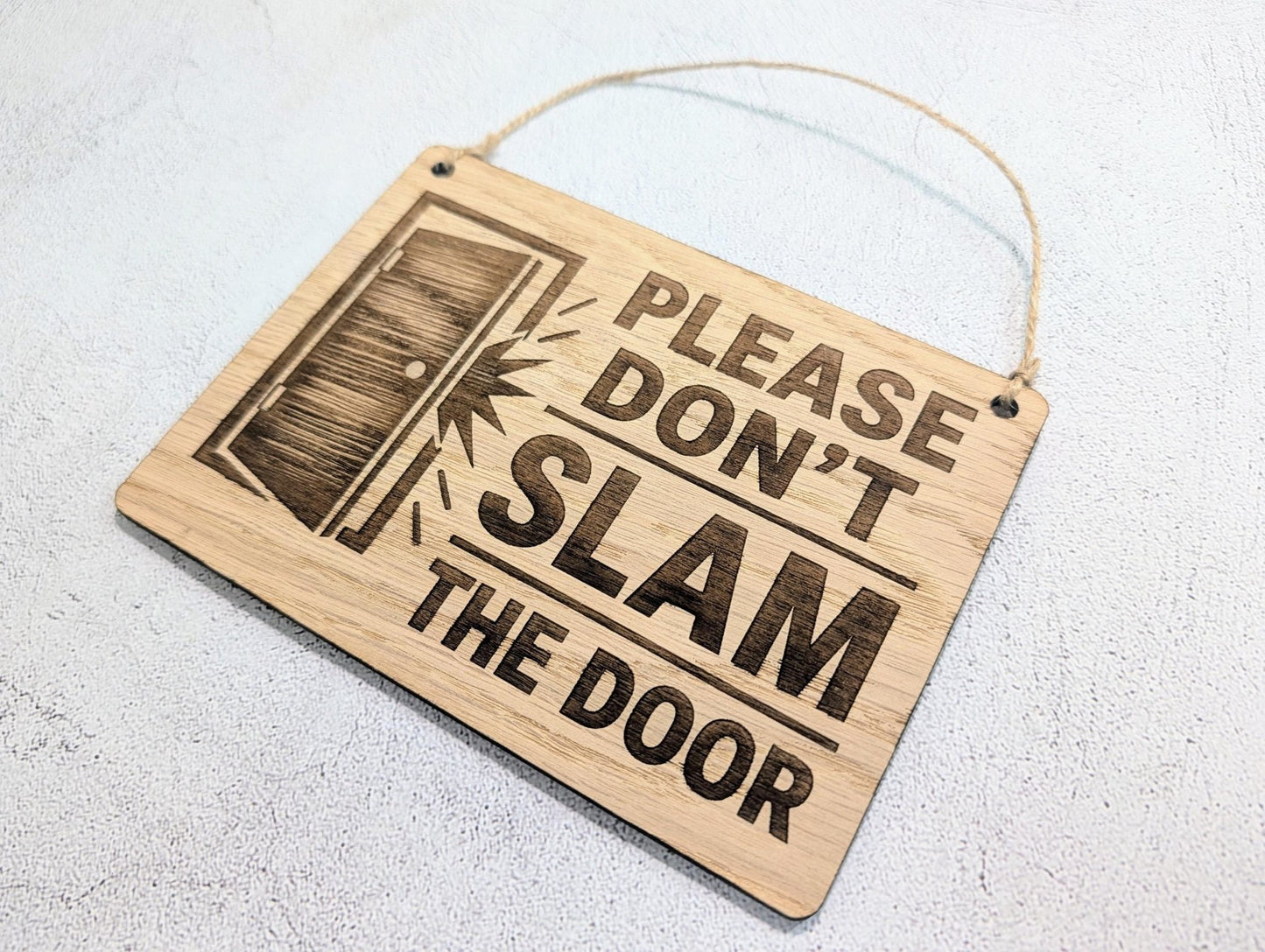 Door Icon sign in shared house hallway setting, oak hanging sign