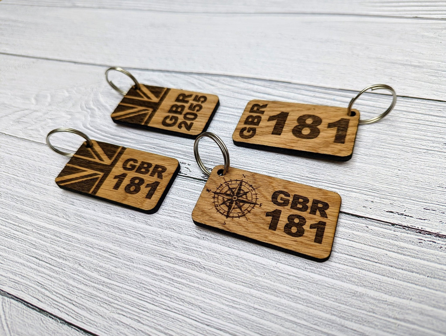 Sail number oak keyring showing size — 65x35mm, personalised with GBR number