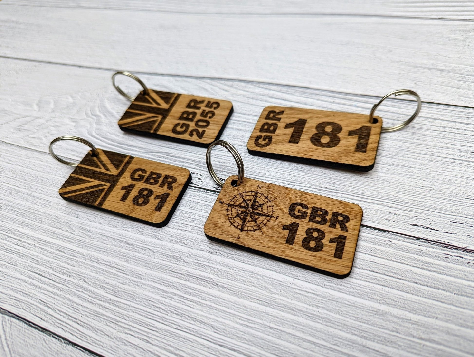 Sail number oak keyring showing size — 65x35mm, personalised with GBR number