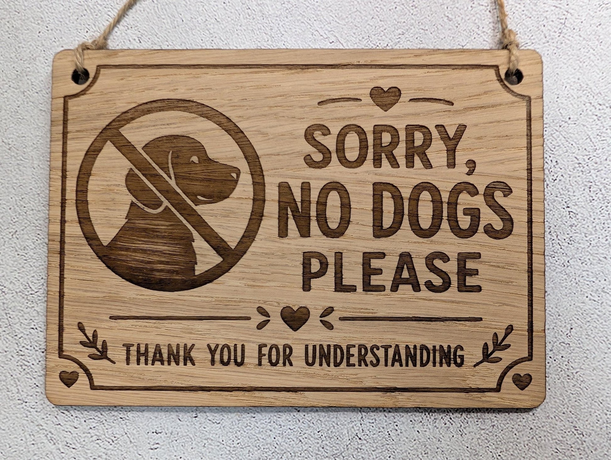 Sorry No Dogs Please wooden sign hung on natural jute twine