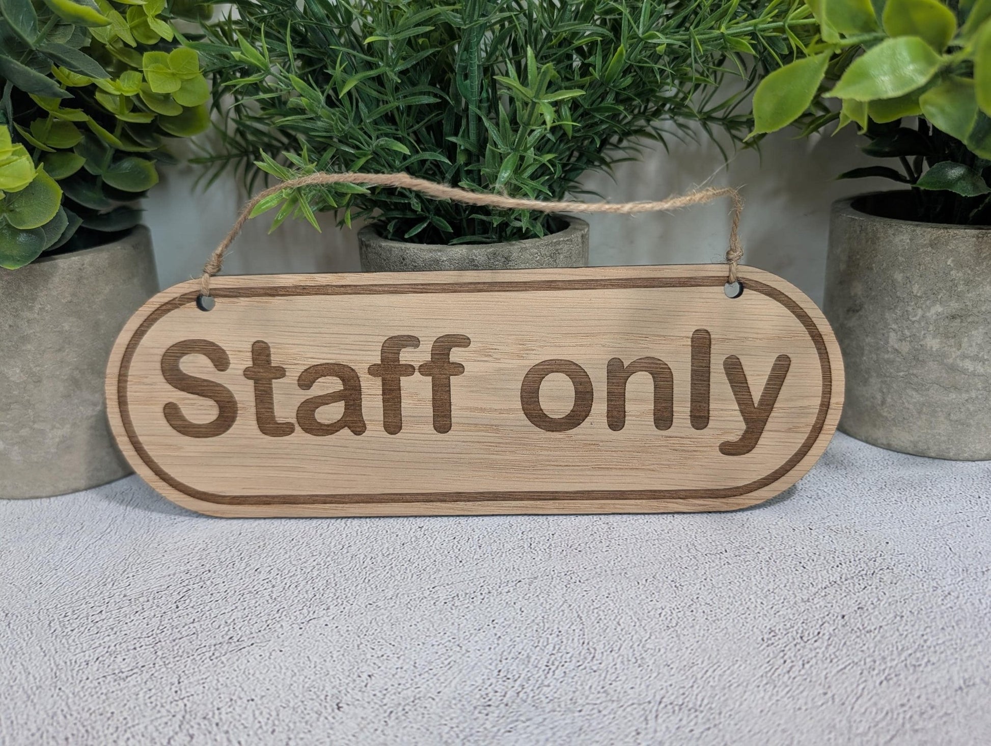 Staff Only oak sign close-up showing laser-engraved lettering and wood grain