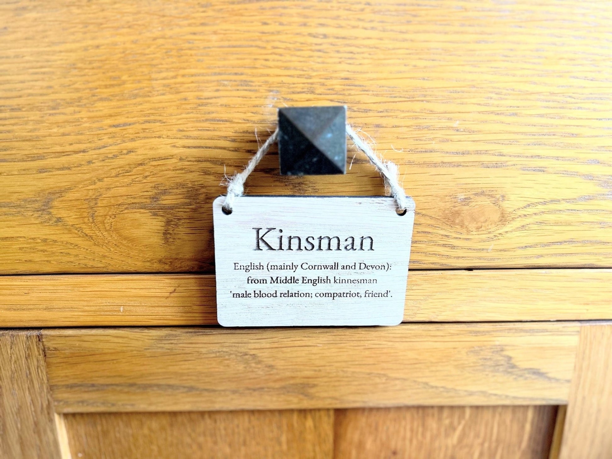 Surname meaning sign close-up — laser engraved text on oak veneered MDF
