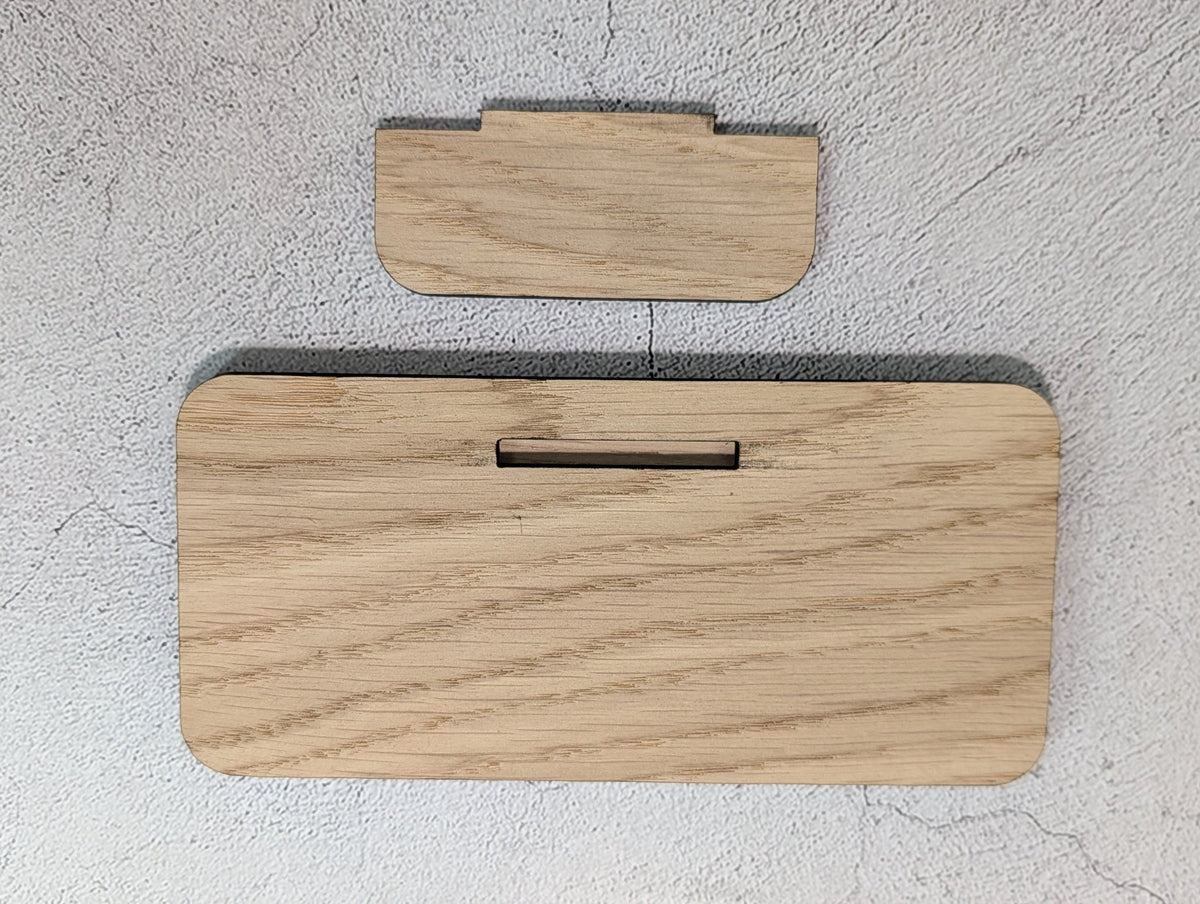 Unassembled QR code stand: back of the oak panel with its slot, and the separate tab stand that pushes into it