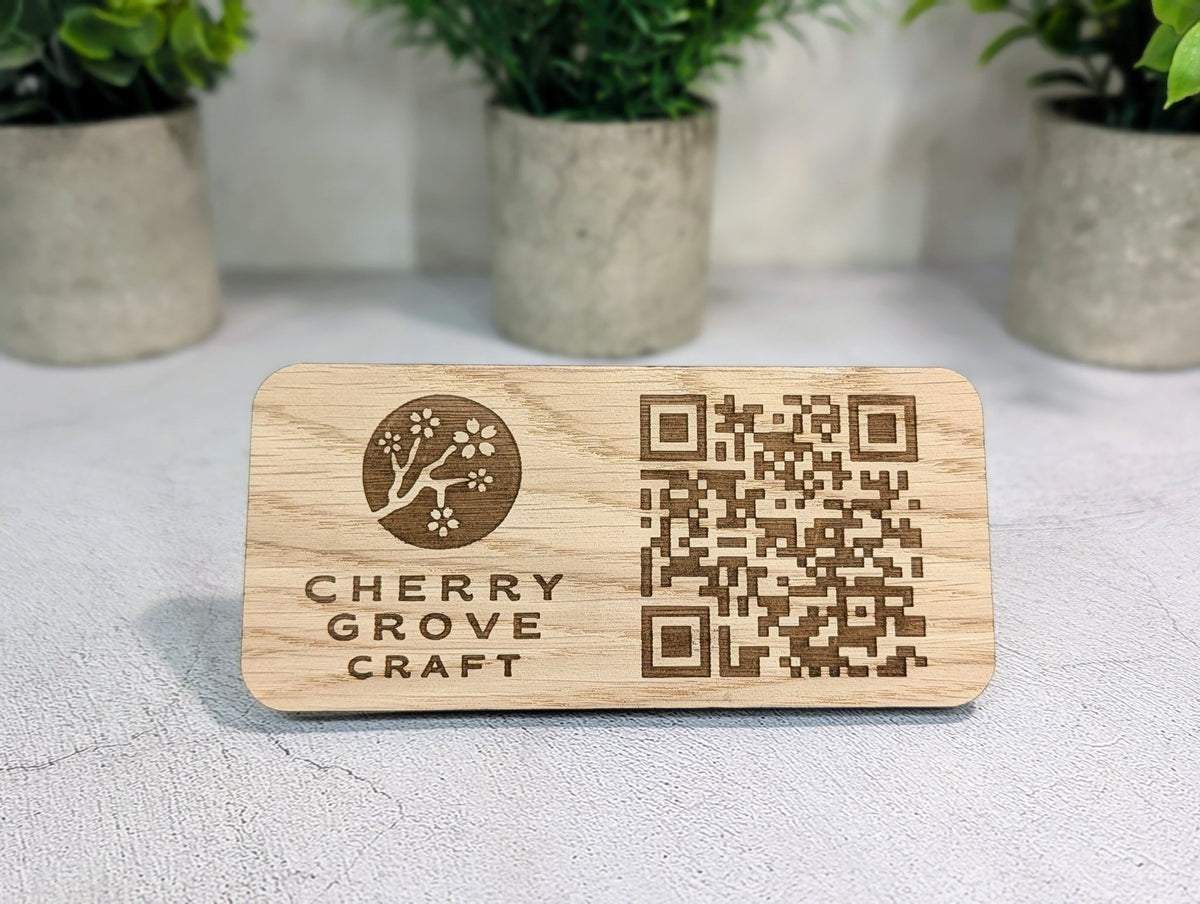 Back of the oak QR code stand with the 4mm tab stand slotted in, holding the panel upright