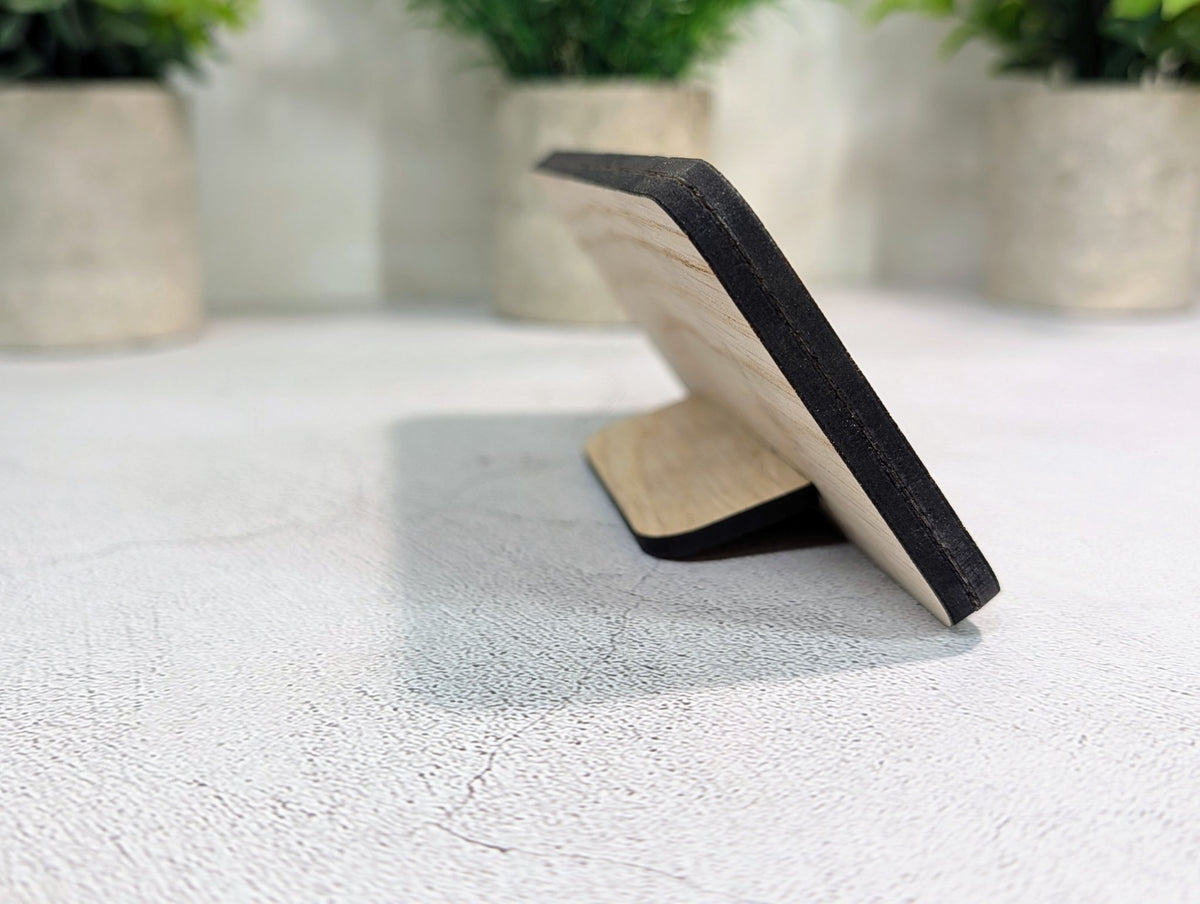 Side view of the QR code stand: the 8mm two-layer oak panel leaning back on its slot-in tab stand