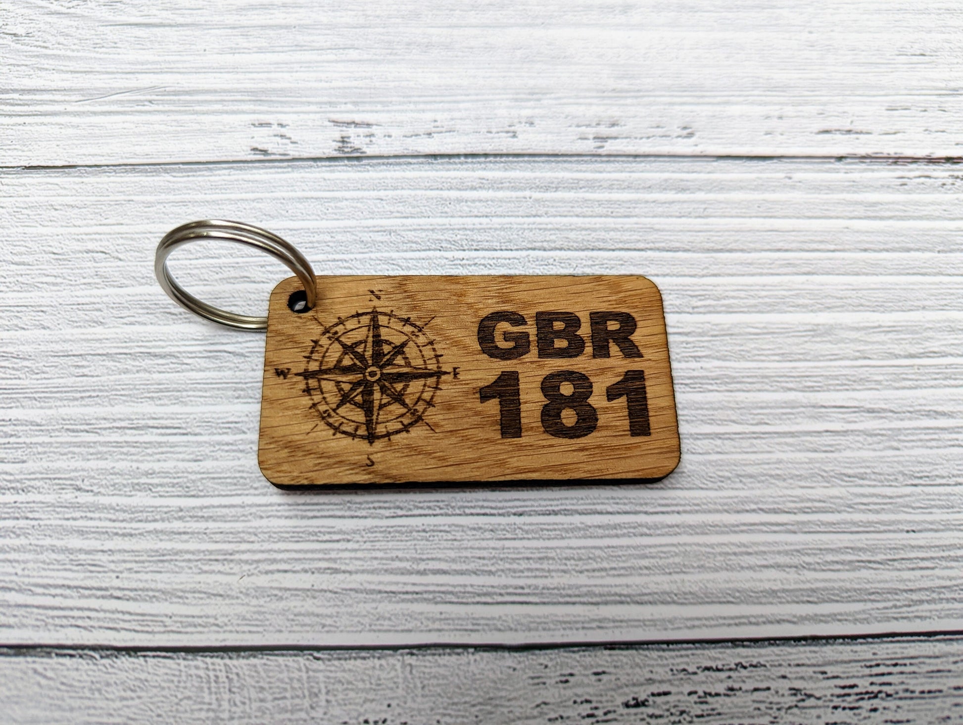 Sailing sail number keyrings — four designs shown, personalised GBR prefix